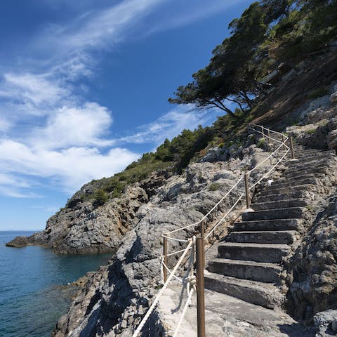 Follow the private staircase down the cliffside to your own rocky platform on the sea