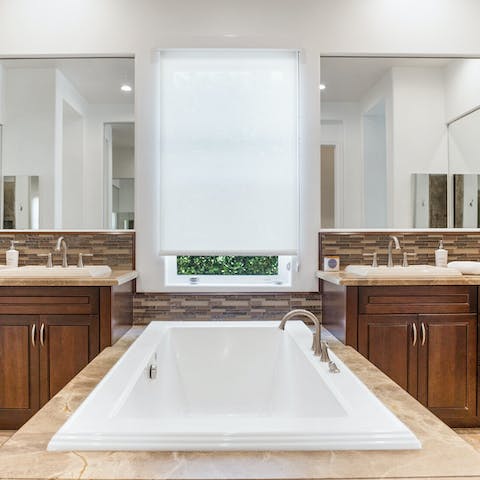 Luxuriate in the beautiful marble-encompassed bathtub in the master ensuite
