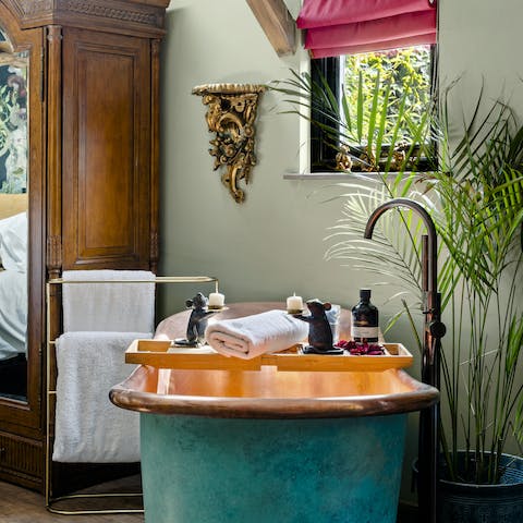 Treat yourself to a relaxing soak in the resplendent copper bathtub