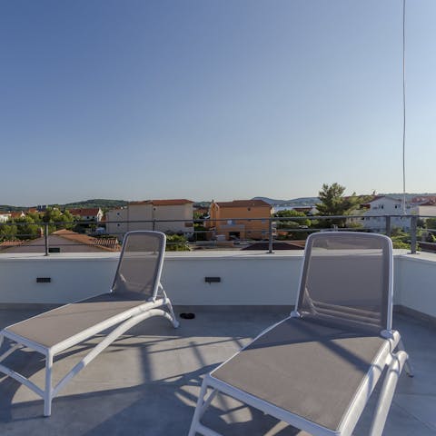 Sunbathe up on the rooftop terrace with your holiday read in hand