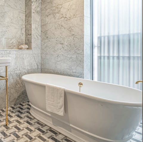 Soak sore feet after sightseeing in the lavish bathtub