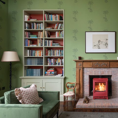 Choose a book from the library shelves and curl up in front of the fire