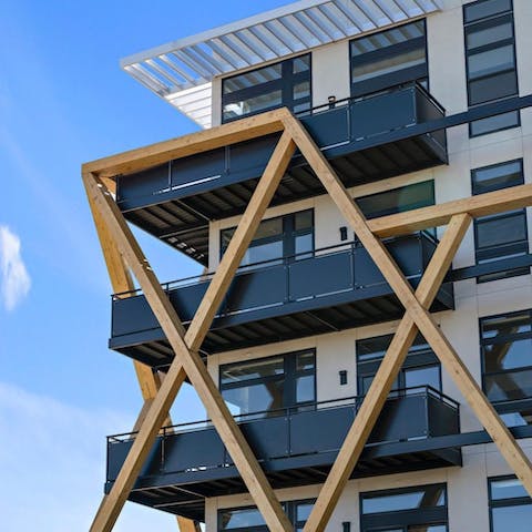 Admire the striking facade of the building, decked out in timber