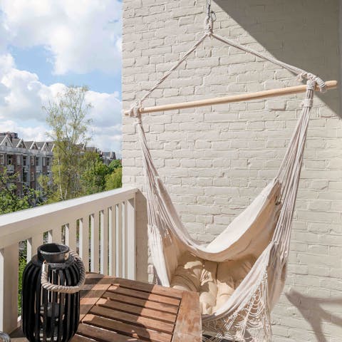 Relax in the hammock chair on the balcony as the sun warms your skin