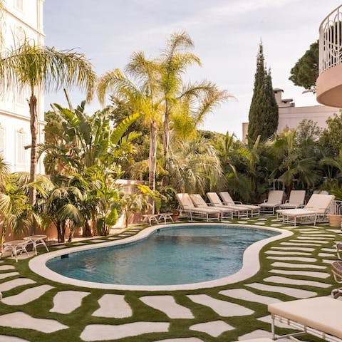 Savour a lazy afternoon relaxing by the shared pool