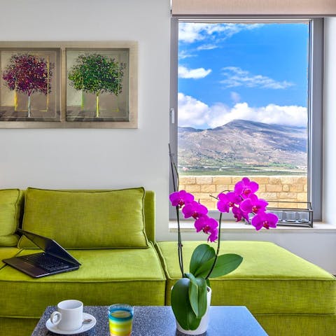 Enjoy spectacular sea and mountain views from the living room's picture windows