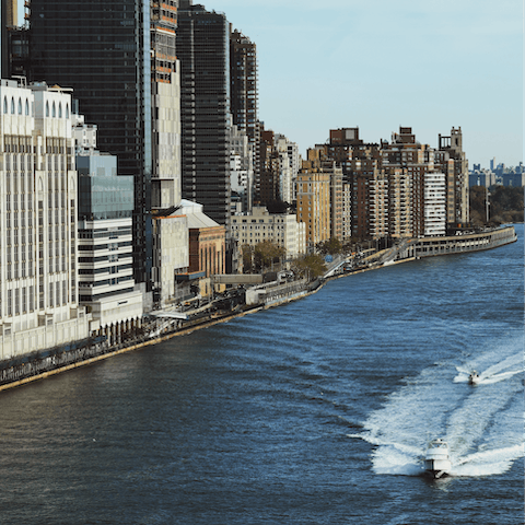 Stroll along the East River Greenway, a thirteen-minute walk away