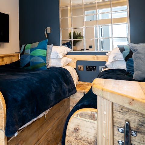 Drift off to your favourite bedtime tale in the rustic wooden twin beds