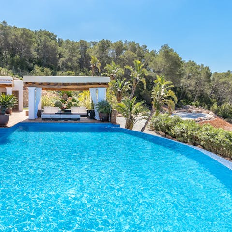 Relax in the Ibizan sun on a daybed by the private pool