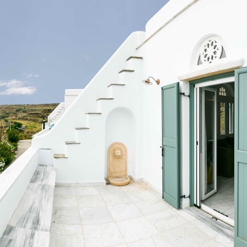 Step onto the balcony and gaze out over rural Tinos