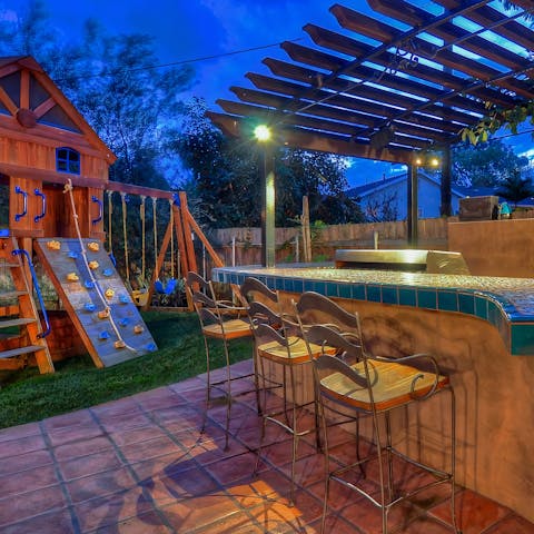 Rustle up a barbecue at the outdoor kitchen-bar area, while the kids have fun at the home playground 