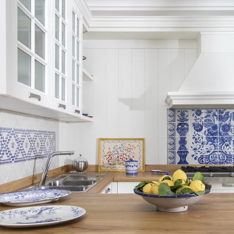Cook in the kitchen adorned in traditional tiles