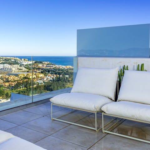 Relax on the private terrace with a cocktail, admiring the coastal views