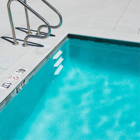 Swim laps in the building's communal pool