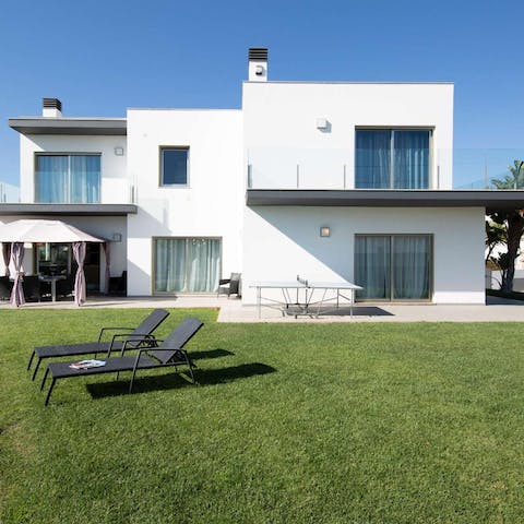 Stay in a striking modern villa surrounded by lawns