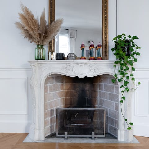 Admire the traditional Parisian touches like the ornate fireplace