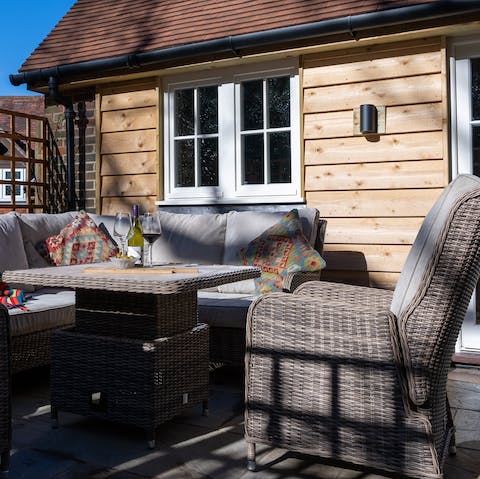 Relax on the outdoor furniture with a glass of wine