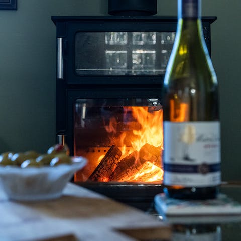 Cosy up by the fire after a day out walking through the lovely landscapes nearby