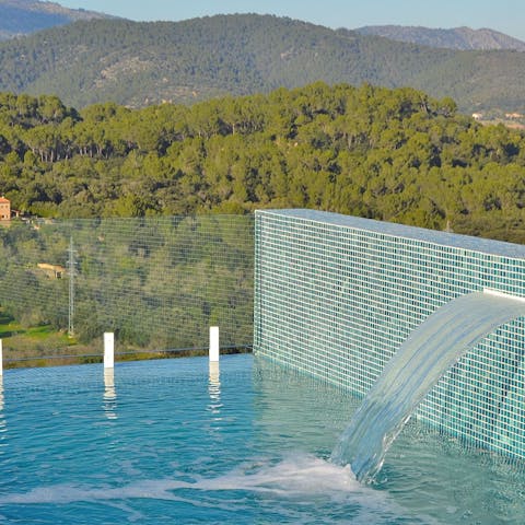 Admire the forest views from the saltwater pool with its water blade