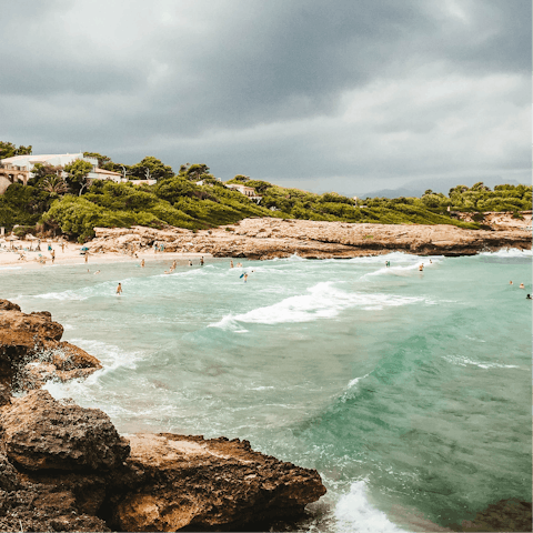 Head to the white sand beaches of Puerto de Alcudia, a twenty-minute drive away