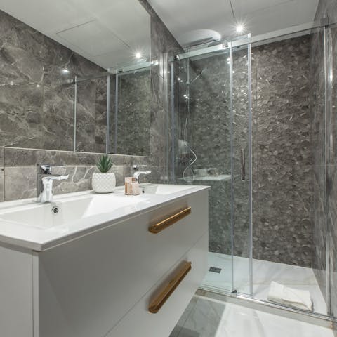 Get ready in the stylish bathroom with its textured tiles, ahead of a night out in Cannes