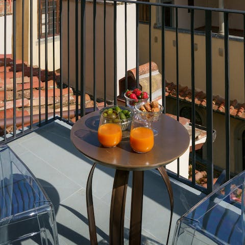 Sit down with a glass of Italian wine on the small balcony as the sun sets