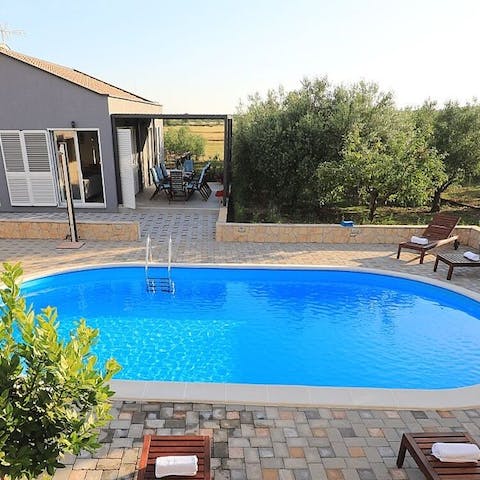 Plunge into your delightful private pool and sun yourself on the loungers
