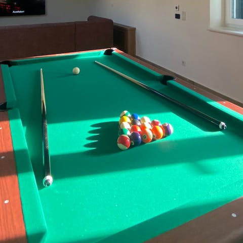 Challenge a friend to a game of pool in the billiards room