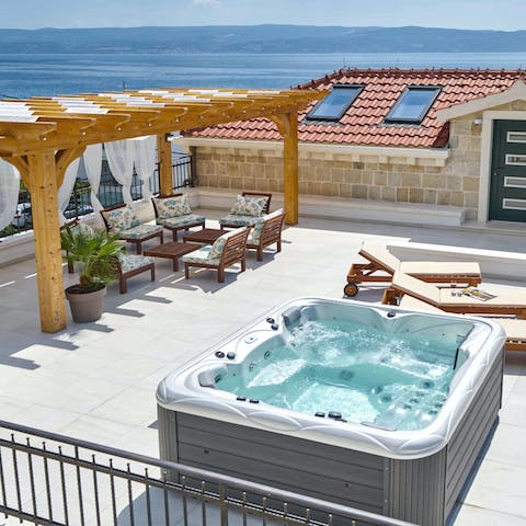Hide away on your rooftop terrace with sea views as you soak in the Jacuzzi