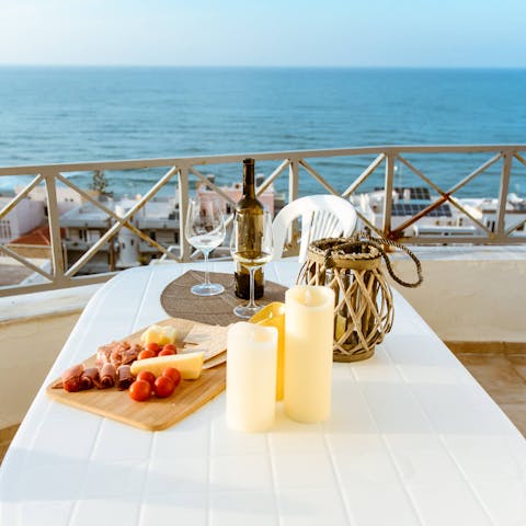 Tuck into delicious Cretan cuisine while enjoying sea views from the alfresco dining table