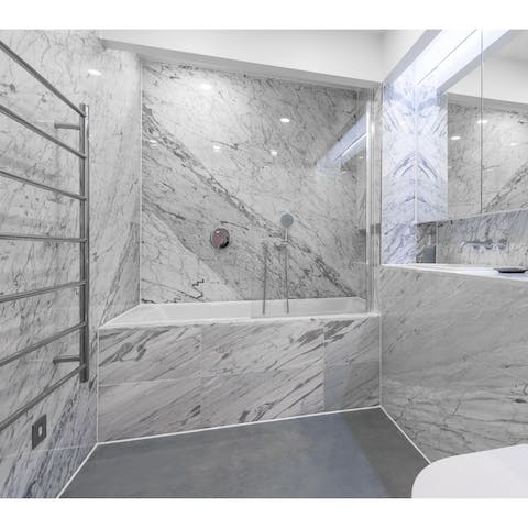 Indulge in a spa-worthy soak in the tub in the main marble bathroom