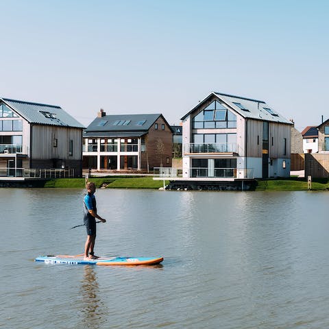 Hire out paddle boards from the activity hub to explore the lakes
