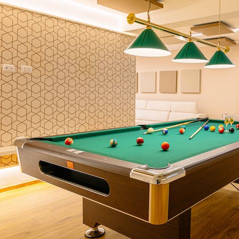 Challenge all comers to games of pool in well-equipped basement