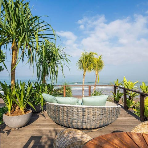 Sink into the daybed with your holiday read overlooking the lapping waves