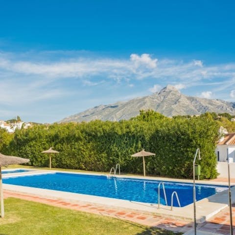 Cool off in the residents' swimming pool with the mountains as a backdrop
