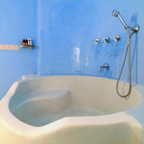 Finish the day with a long soak in the bright blue bathroom's tub