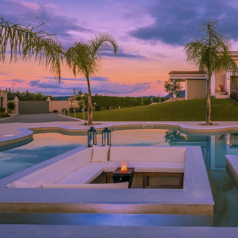 Watch the magical sunset from your 70s-style conversation pit, sipping on drinks while basking in the luxury