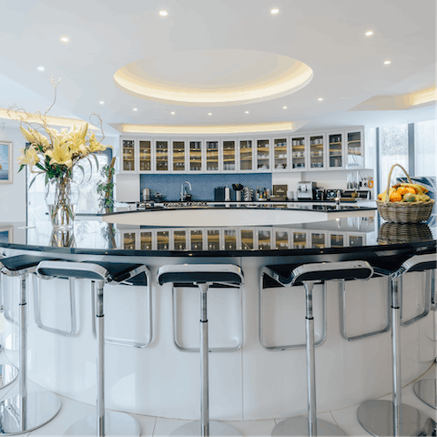 Sit down for a cocktail at the curved kitchen bar