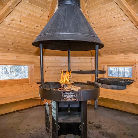 Cook on an open fire inside the fire pit hut