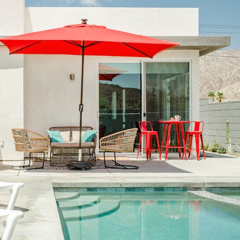 Have a dip in the inviting pool or get some shade underneath the red umbrella