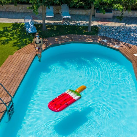 Spend lazy days lounging by the pool and reading books in the shade of the trees