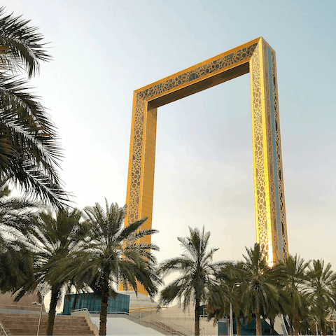 Capture that perfect shot under the iconic Dubai Frame, a short drive away