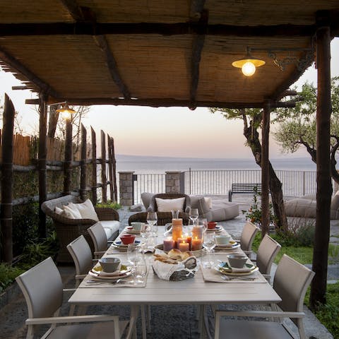 Serve up a delicious alfresco meal as the sun goes down across the water