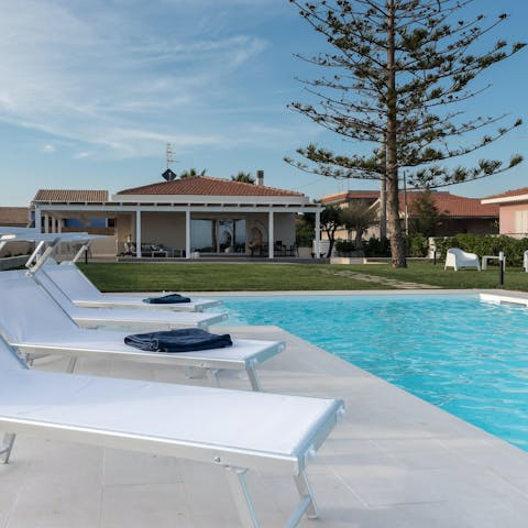 Relax and soak up the sun by the private pool 