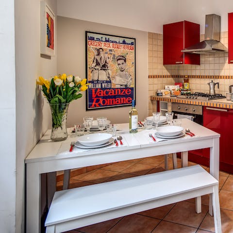 Tuck into some cacio e pepe at your dining table in the vibrant red kitchen