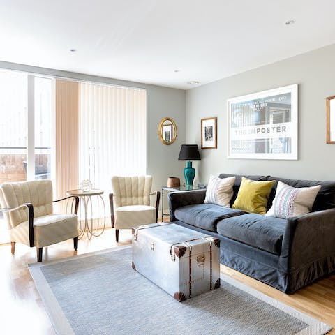 Kick back in the bright living room with a glass of wine after a day of exploring London on foot