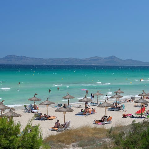 Spend sunny afternoons at Playa de Muro, a twenty-minute drive away