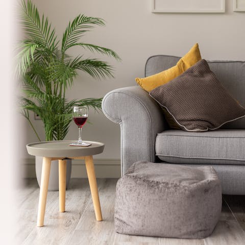 Snuggle up with a glass of wine on the cosy sofa after a long day