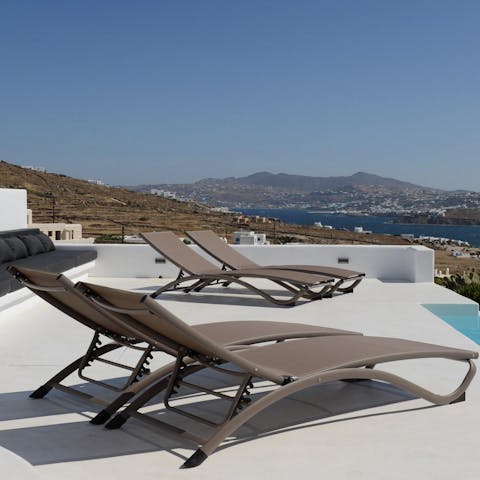 Pour an ice-cold drink and soak up the glorious Greek sunshine from a lounger