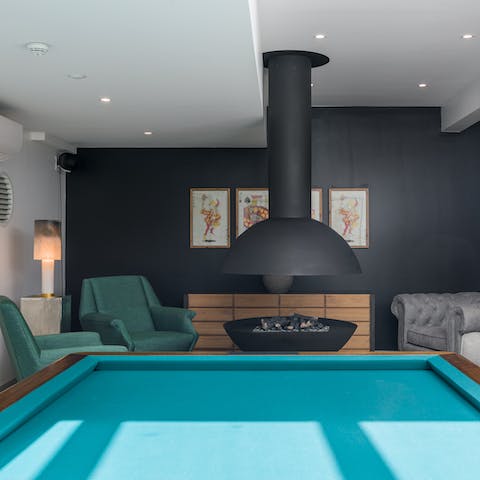 Play a round of pool and then relax by the indoor firepit in the communal lounge